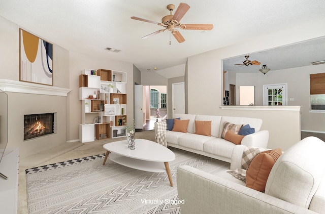 living room featuring plenty of natural light, ceiling fan, and carpet floors