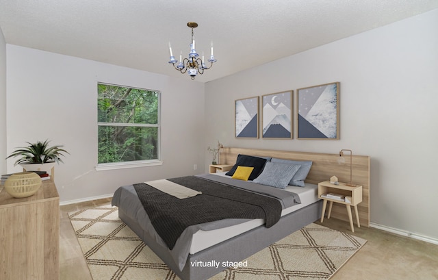 carpeted bedroom featuring a notable chandelier and a textured ceiling