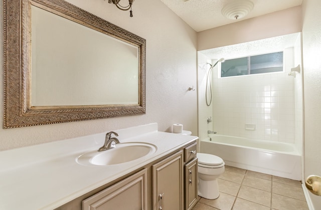 full bathroom with toilet, tile flooring, tiled shower / bath, vanity, and a textured ceiling