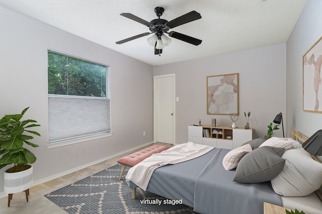 bedroom featuring ceiling fan and a textured ceiling