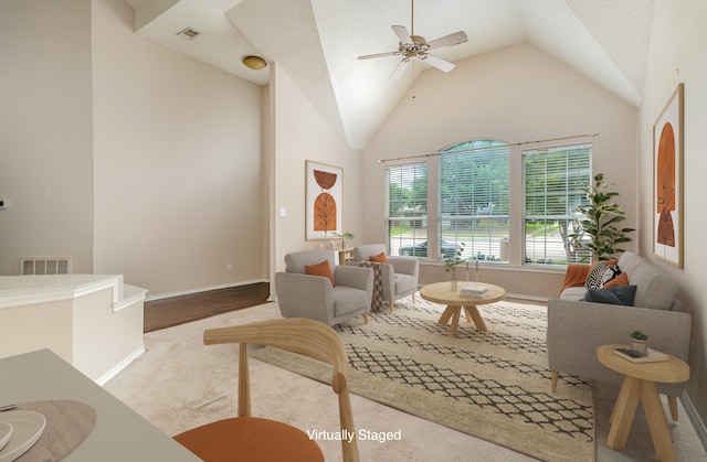 carpeted living room featuring high vaulted ceiling and ceiling fan