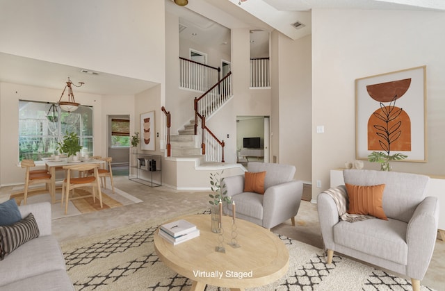 living room with light colored carpet and a high ceiling