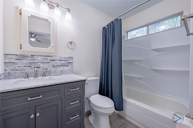 full bathroom featuring backsplash, ceiling fan, toilet, vanity, and shower / tub combo with curtain