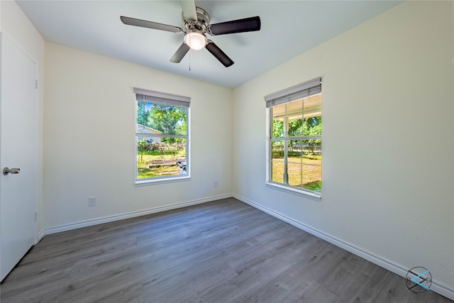 empty room featuring ceiling fan and hardwood / wood-style floors