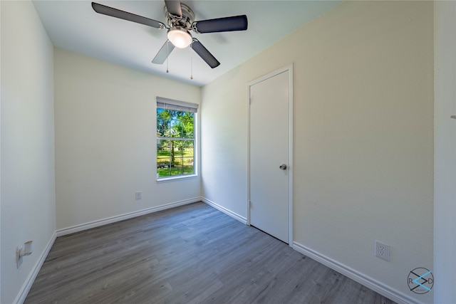 unfurnished bedroom with ceiling fan and hardwood / wood-style flooring