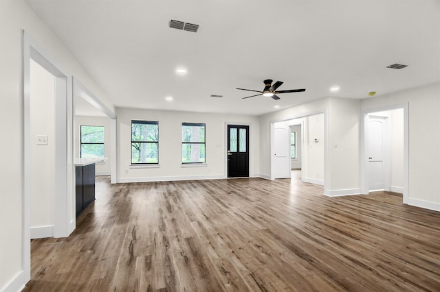 unfurnished living room featuring ceiling fan and hardwood / wood-style floors