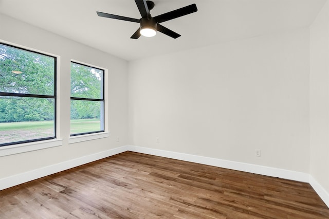 spare room with hardwood / wood-style floors and ceiling fan