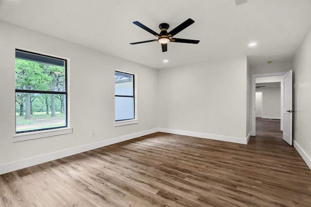 empty room featuring ceiling fan and dark hardwood / wood-style flooring