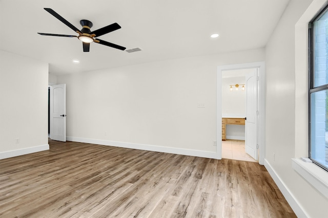 spare room with light wood-type flooring and ceiling fan