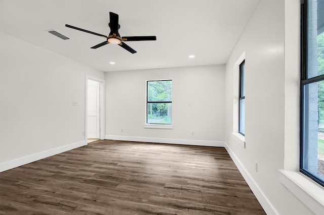 empty room with dark wood-type flooring and ceiling fan