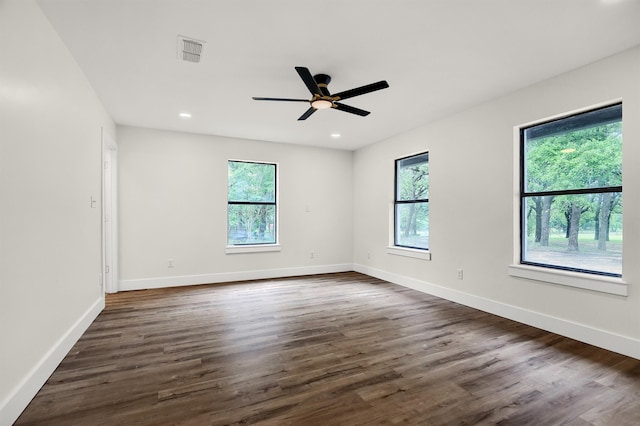 spare room featuring dark hardwood / wood-style floors and ceiling fan