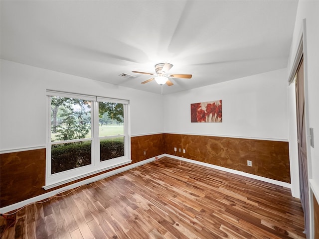 empty room featuring ceiling fan and hardwood / wood-style flooring