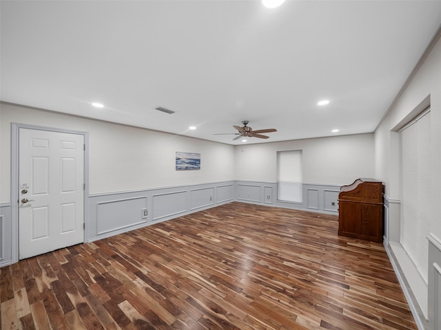 spare room featuring dark hardwood / wood-style flooring and ceiling fan