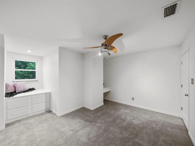 unfurnished bedroom with ceiling fan and light colored carpet