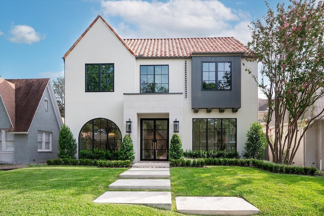 mediterranean / spanish-style house with a front lawn