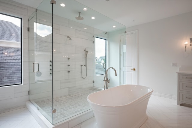 bathroom featuring vanity and separate shower and tub