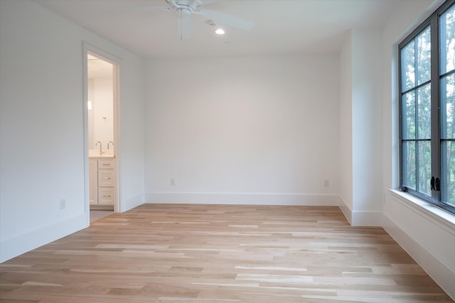 unfurnished room with light hardwood / wood-style flooring, ceiling fan, and a healthy amount of sunlight