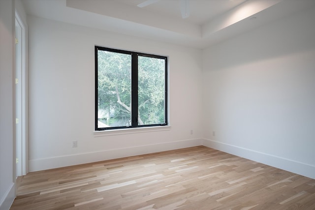 unfurnished room with light wood-type flooring, a healthy amount of sunlight, and ceiling fan