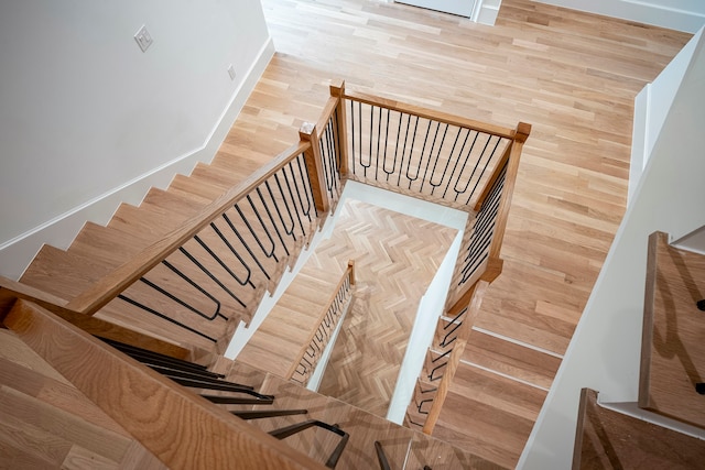 stairs with hardwood / wood-style flooring