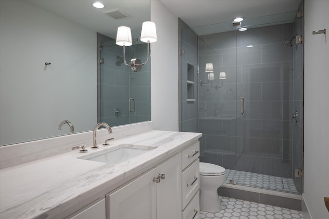 bathroom with tile patterned floors, an enclosed shower, vanity, and toilet