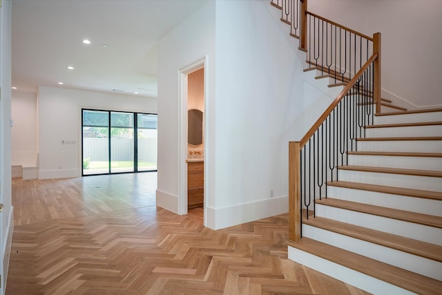 stairs featuring parquet floors