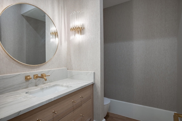 bathroom featuring vanity, hardwood / wood-style floors, and toilet