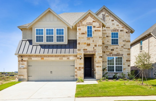 view of front of home featuring a front lawn and a garage