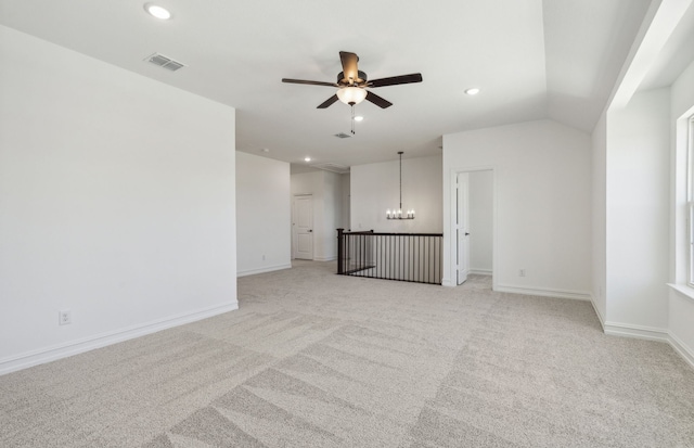 unfurnished living room featuring light colored carpet and ceiling fan with notable chandelier