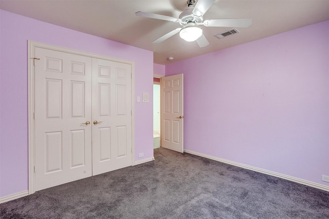 unfurnished bedroom with ceiling fan, a closet, and dark carpet