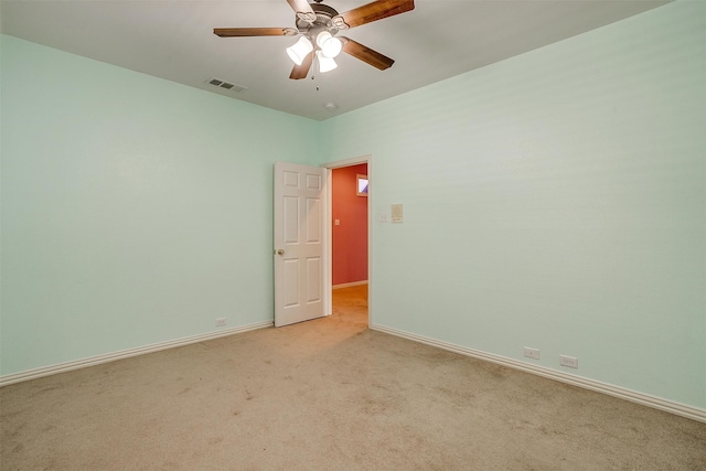 unfurnished room with light colored carpet and ceiling fan