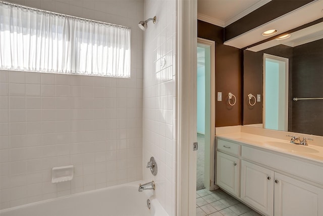 bathroom featuring tile patterned flooring, tiled shower / bath, crown molding, and vanity