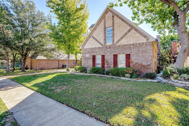 view of front of home with a front lawn and central air condition unit