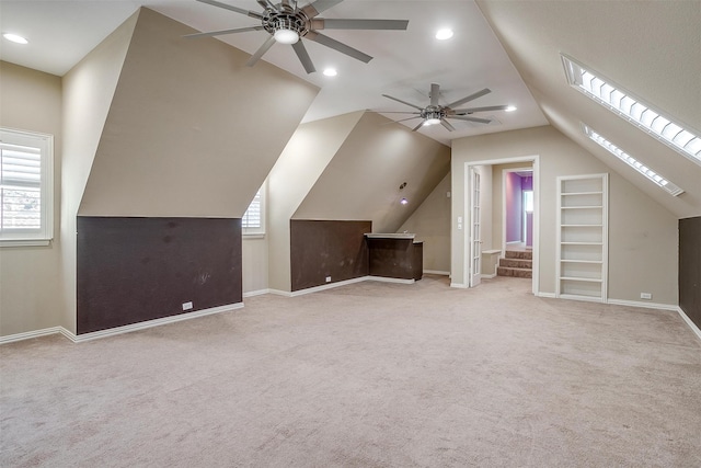 bonus room with ceiling fan, light carpet, and lofted ceiling