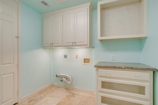 washroom featuring hookup for a washing machine, cabinets, hookup for a gas dryer, and hookup for an electric dryer