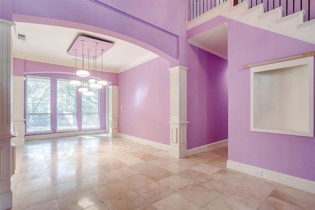 tiled spare room featuring ornamental molding, decorative columns, and an inviting chandelier