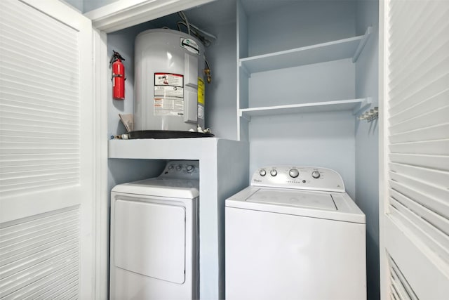 laundry area with washer and clothes dryer and water heater