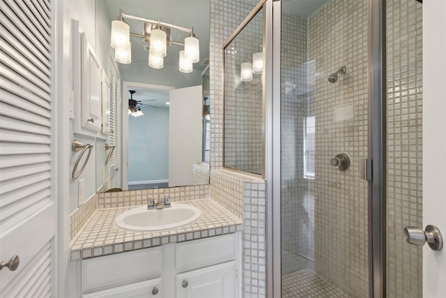 bathroom with an enclosed shower, vanity, and ceiling fan