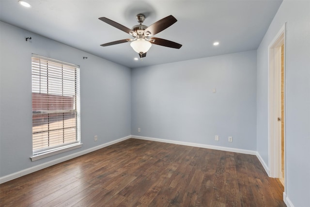 unfurnished room with ceiling fan, a healthy amount of sunlight, and dark wood-type flooring