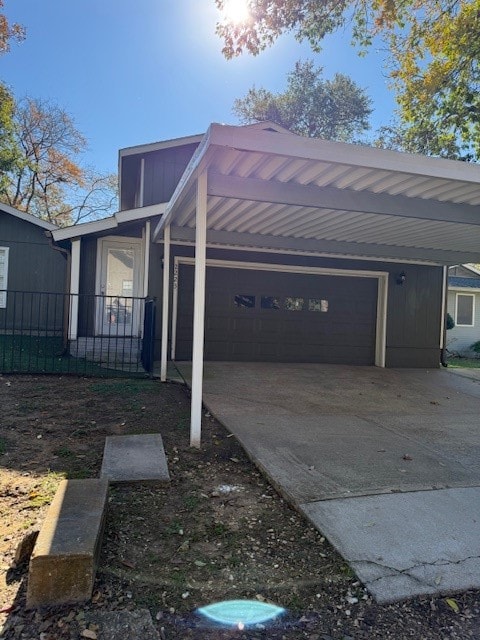 view of property exterior featuring a carport and a garage