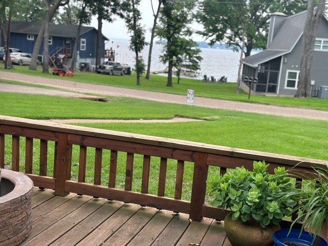 wooden terrace with a lawn