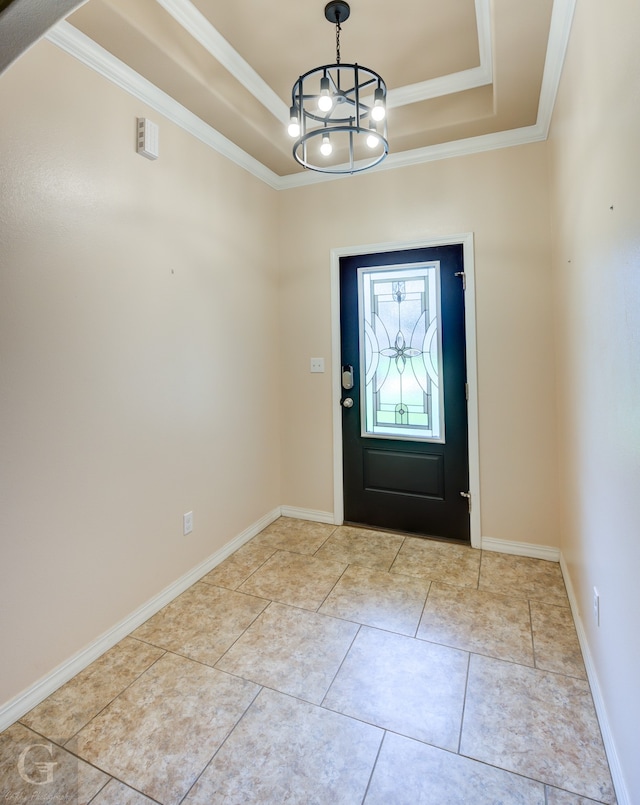 tiled entrance foyer featuring a notable chandelier, a raised ceiling, and crown molding