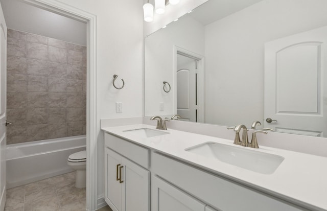 full bathroom featuring tiled shower / bath combo, tile patterned flooring, vanity, and toilet