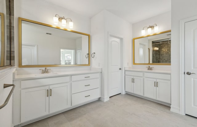 bathroom with a tile shower, tile patterned flooring, and vanity