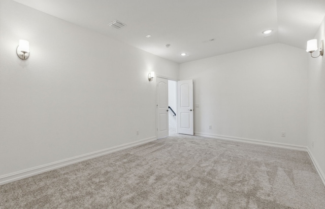 unfurnished room featuring vaulted ceiling and carpet