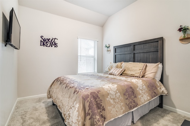 carpeted bedroom featuring lofted ceiling