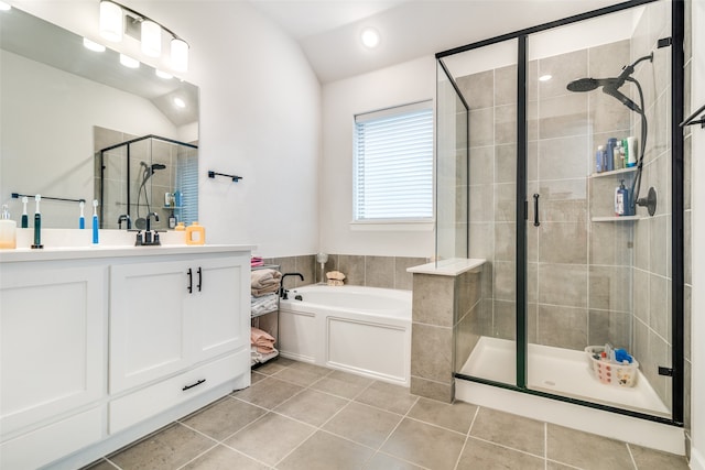 bathroom featuring tile floors, lofted ceiling, vanity, and plus walk in shower