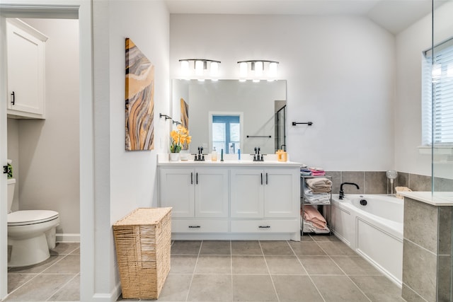 bathroom featuring oversized vanity, toilet, a bath, and tile floors