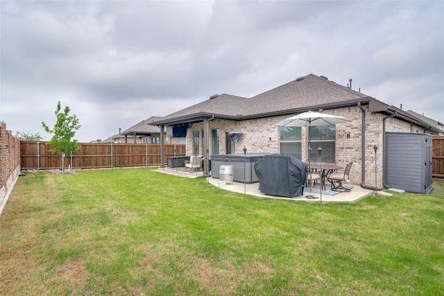 back of property featuring a patio and a yard