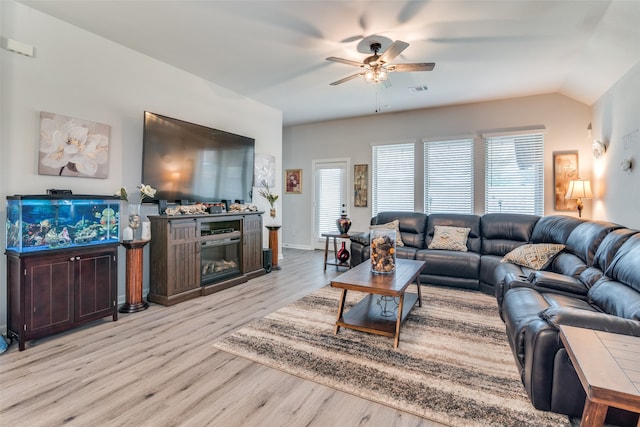 living room with plenty of natural light, ceiling fan, and light wood-type flooring