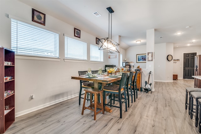 dining space featuring a chandelier and light wood-type flooring